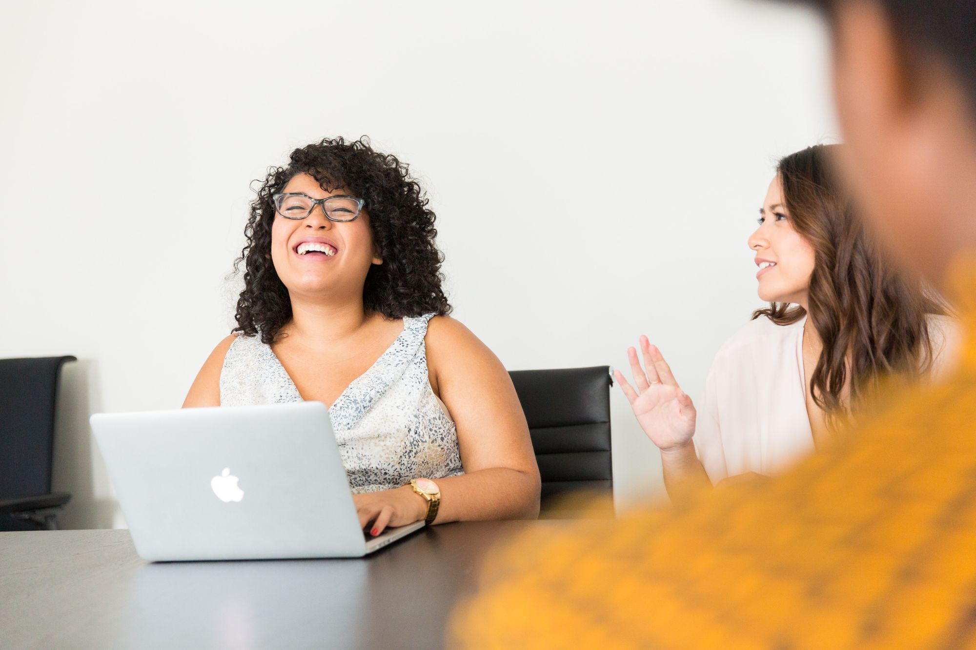 two women look happy and sit across from a candidate