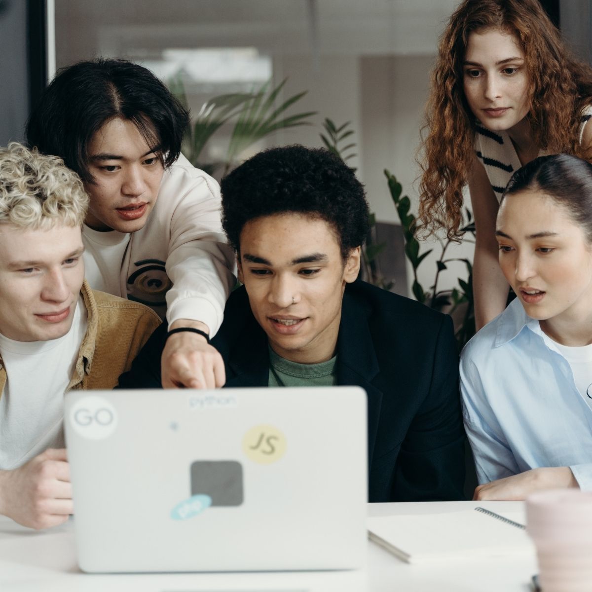 group crowds around computer screen