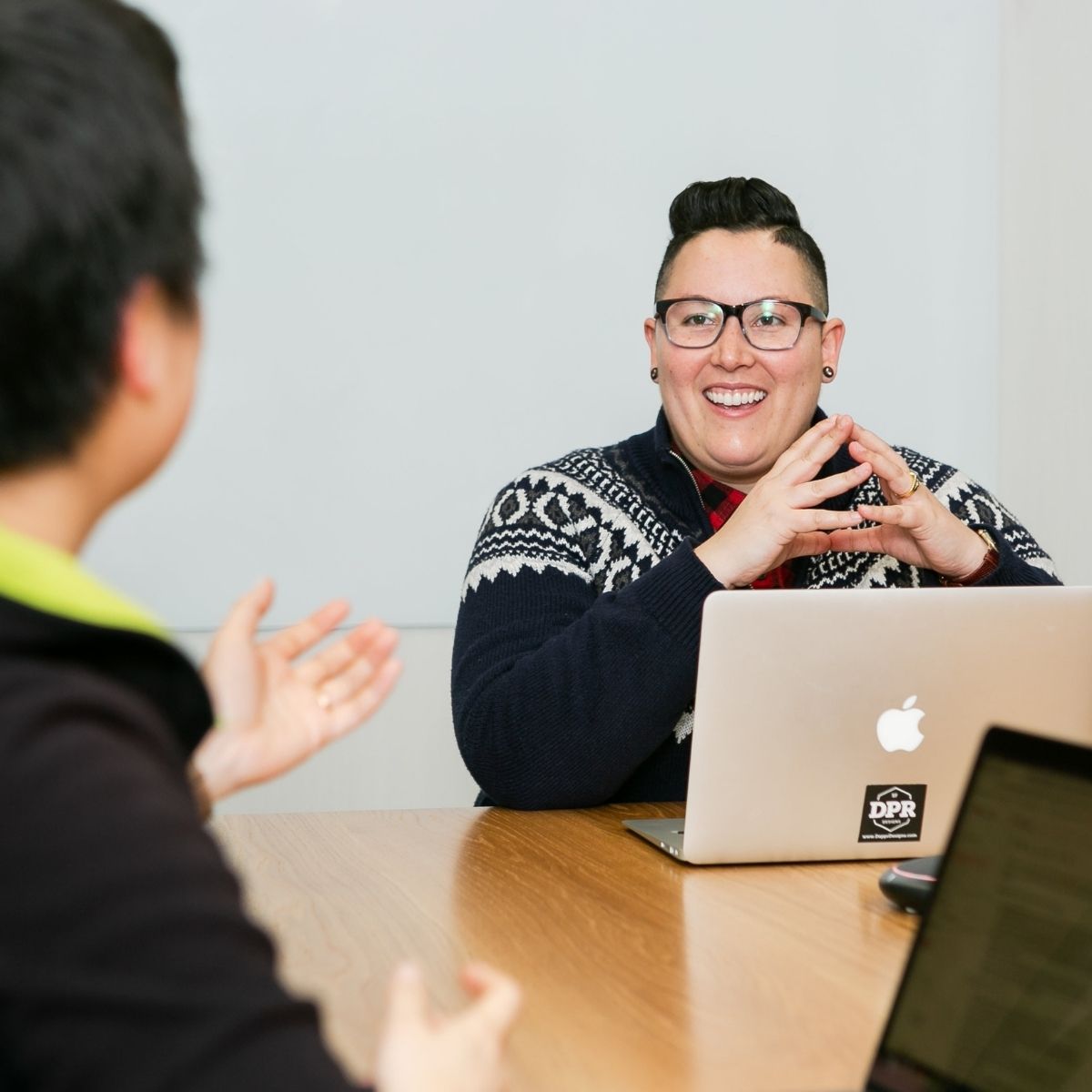two happy people chat during a meeting