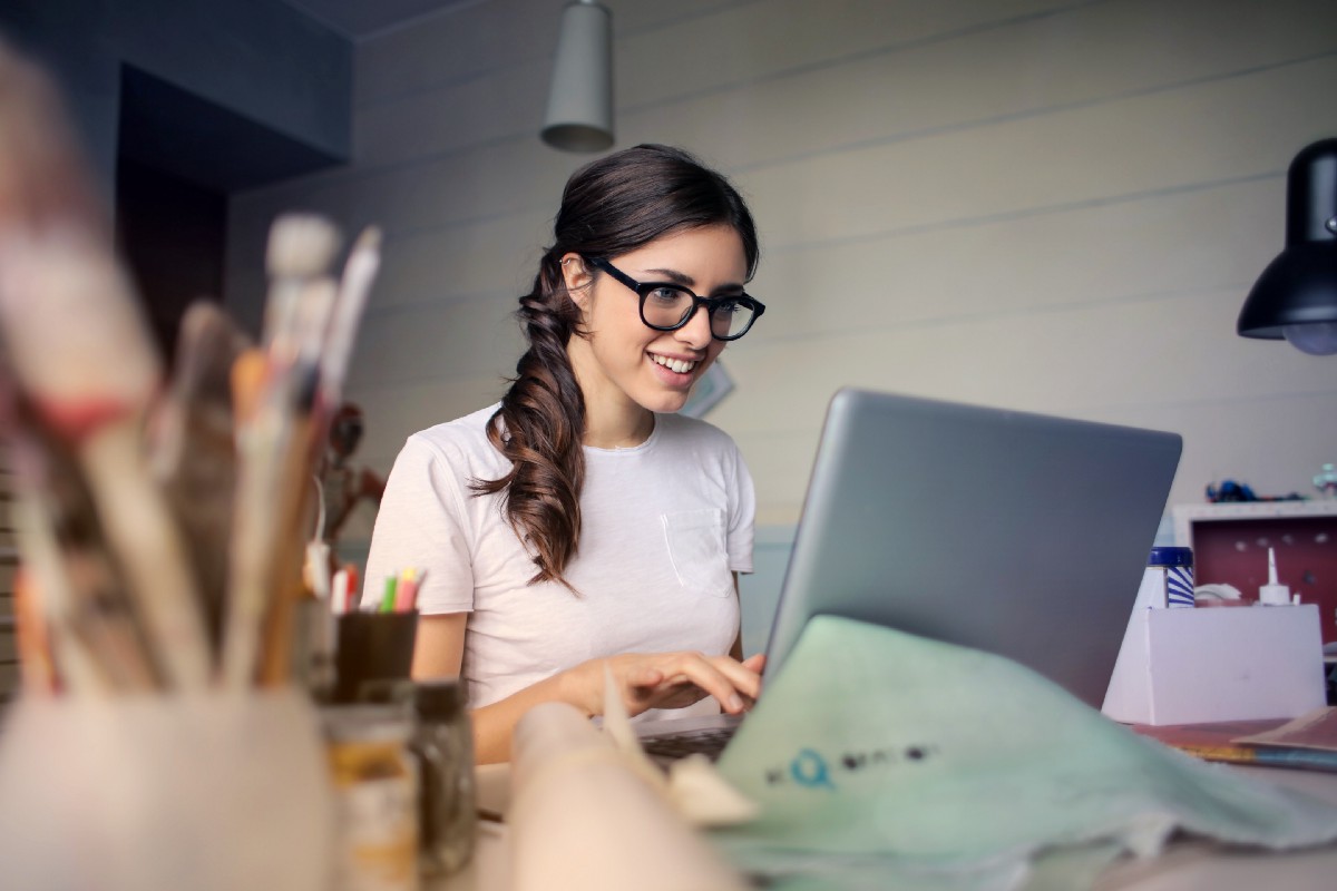 Girl happily typing away at computer